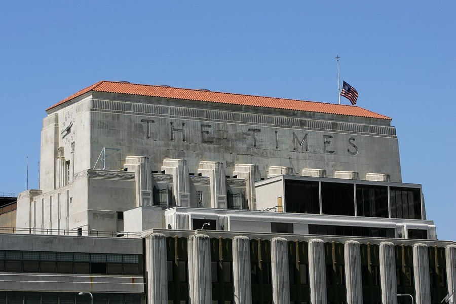 <p>LOS ANGELES – APRIL 23:  A flag flies half-staff on top of the Los Angeles Times building April 23, 2007 in Los Angeles, California. The Times announced today that it will offer voluntary buyouts in an effort to cut its staff of 2,625 by up to 150. Up to about 70 of those jobs would be in the newsroom, dropping the news staff to about 850. When the Tribune Co. bought the newspaper in 2000, there were 1,200 employed on the news side. Last fall, publisher Jeffrey M. Johnson and then Editor Dean Baquet were forced from the paper for fighting against cuts in the newsroom and arguing that a reduction of reporters and editors would hurt the quality of the paper, a belief contrary to that of Tribune executives.  (Photo by David McNew/Getty Images)</p>