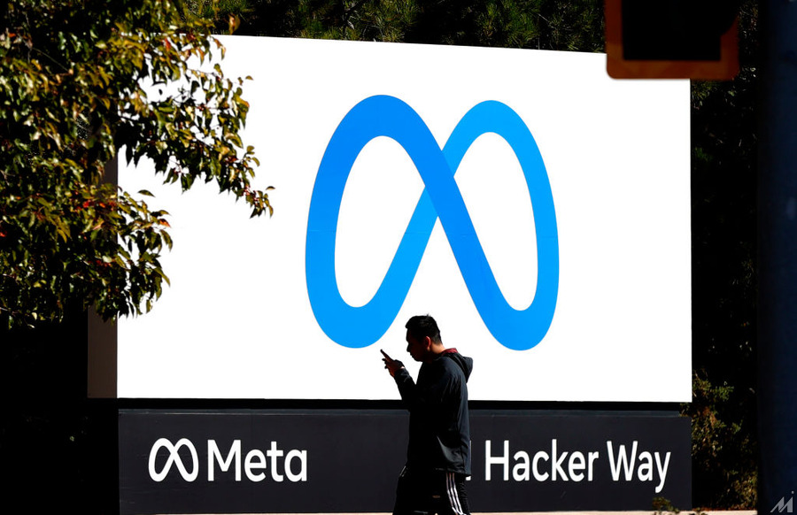 <p>MENLO PARK, CALIFORNIA – OCTOBER 28: A pedestrian walks in front of a new logo and the name ‘Meta’ on the sign in front of Facebook headquarters on October 28, 2021 in Menlo Park, California. A new name and logo were unveiled at Facebook headquarters after a much anticipated name change for the social media platform. (Photo by Justin Sullivan/Getty Images)</p>