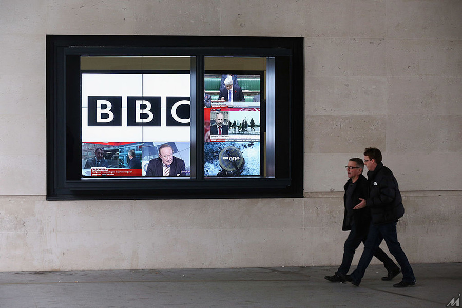 <p>LONDON, ENGLAND – NOVEMBER 12:  Men walk past a bank of television screens displaying BBC channels in the BBC headquarters at New Broadcasting House on November 12, 2012 in London, England. Tim Davie has been appointed the acting Director General of the BBC following the resignation of George Entwistle after the broadcasting of an episode of the current affairs programme ‘Newsnight’ on child abuse allegations which contained errors.  (Photo by Oli Scarff/Getty Images)</p>