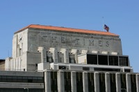 <p>LOS ANGELES – APRIL 23:  A flag flies half-staff on top of the Los Angeles Times building April 23, 2007 in Los Angeles, California. The Times announced today that it will offer voluntary buyouts in an effort to cut its staff of 2,625 by up to 150. Up to about 70 of those jobs would be in the newsroom, dropping the news staff to about 850. When the Tribune Co. bought the newspaper in 2000, there were 1,200 employed on the news side. Last fall, publisher Jeffrey M. Johnson and then Editor Dean Baquet were forced from the paper for fighting against cuts in the newsroom and arguing that a reduction of reporters and editors would hurt the quality of the paper, a belief contrary to that of Tribune executives.  (Photo by David McNew/Getty Images)</p>